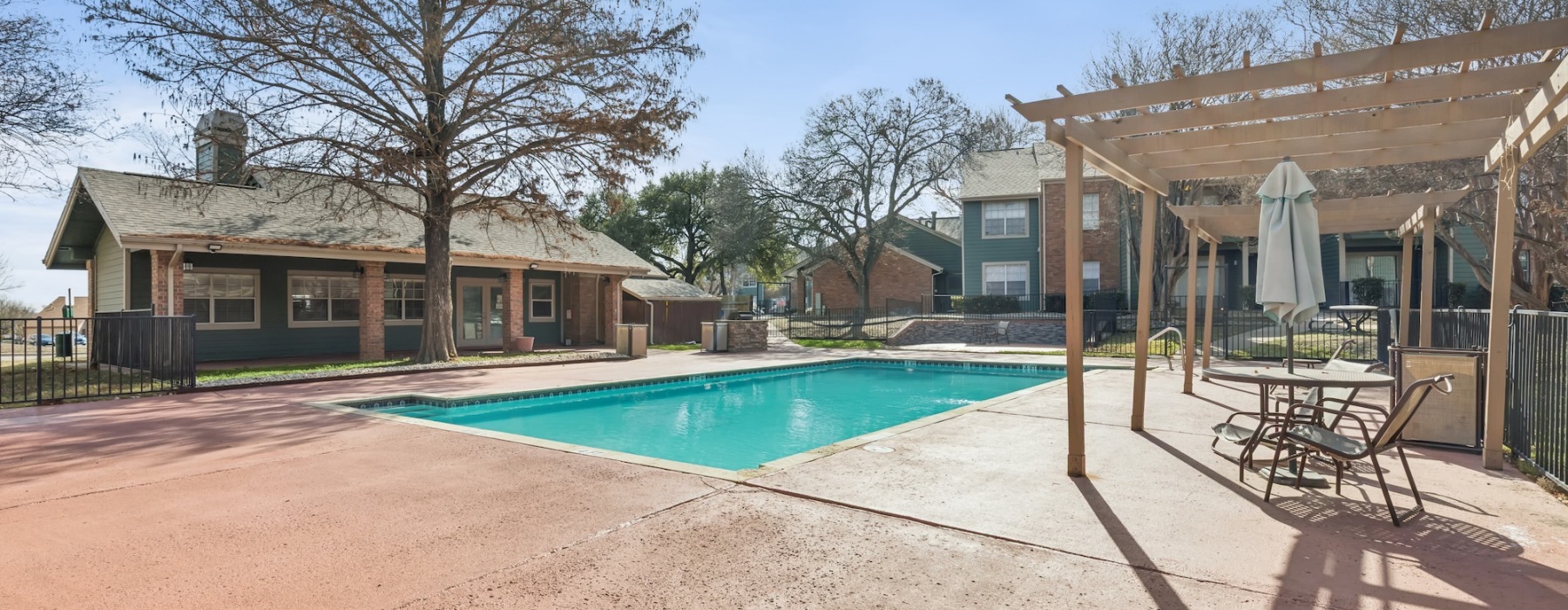 Resort-style swimming pool with lounge seating